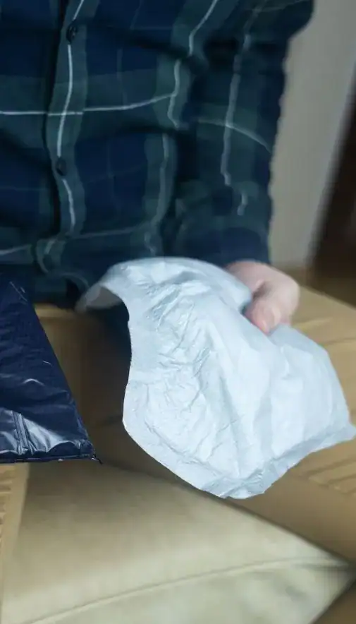 Image of man holding incontinence pads as part of overactive bladder treatment Coventry 