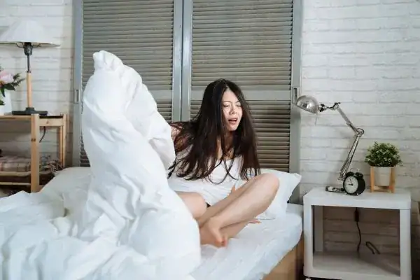 Image of woman getting up because of nighttime leaks Coventry